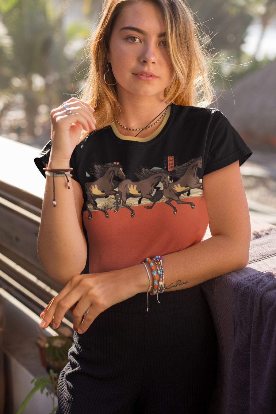 Young woman wearing all over print of chinese horse shirt 2 with sunlight behind her.